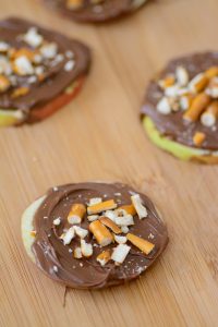 Chcolate Hazelnut & Pretzel Apple "Cookies" Great way to sneak in some healthy food for picky eaters. Perfect after school snack.