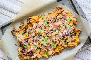 BBQ Chicken and Sweet Potato Nachos. Healthy comfort food! Made with bacon, sweet potato chips and cheese, this healthy nacho recipe is easy to make and super delicious!