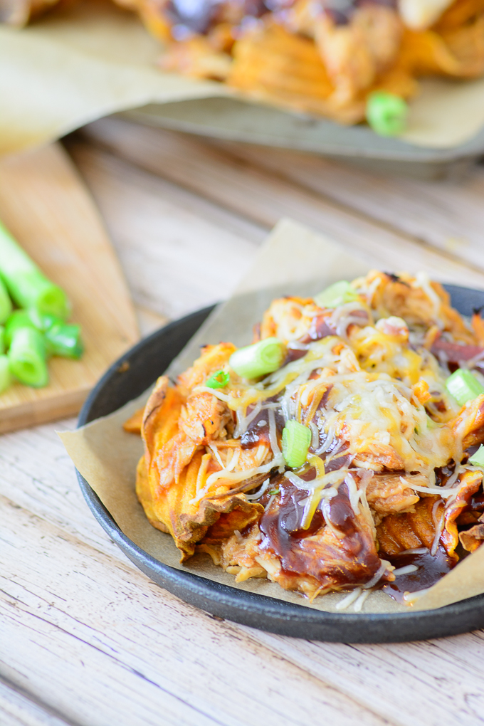 BBQ Chicken and Sweet Potato Nachos. Healthy comfort food! Made with bacon, sweet potato chips and cheese, this healthy nacho recipe is easy to make and super delicious!