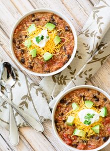 Thick and Hearty Vegetarian Slow Cooker Chili Recipe. Perfect for crisp fall evenings. No prep time needed, just throw the ingredients in your slow cooker and cook on low for 5 hours. So easy!!