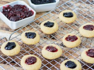 Only 6 ingredients to these melt-in-your-mouth holiday cookies. These Gluten free Jam Thumbprint Cookies are tender, buttery and generously filled with your favorite choice of jam!! Yum!