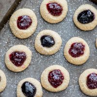 Only 6 ingredients to these melt-in-your-mouth holiday cookies. These Gluten free Jam Thumbprint Cookies are tender, buttery and generously filled with your favorite choice of jam!! Yum!