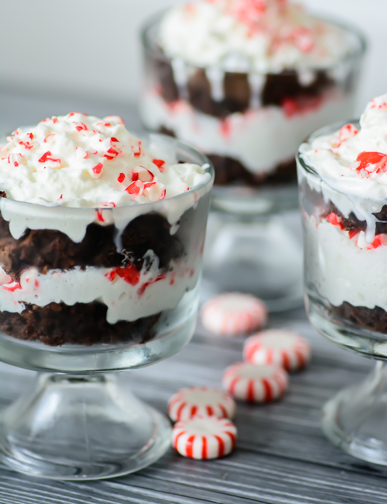 Decadent peppermint brownies topped with whipped cream and crushed candy canes. This peppermint brownie trifle is to die for! YUM!!
