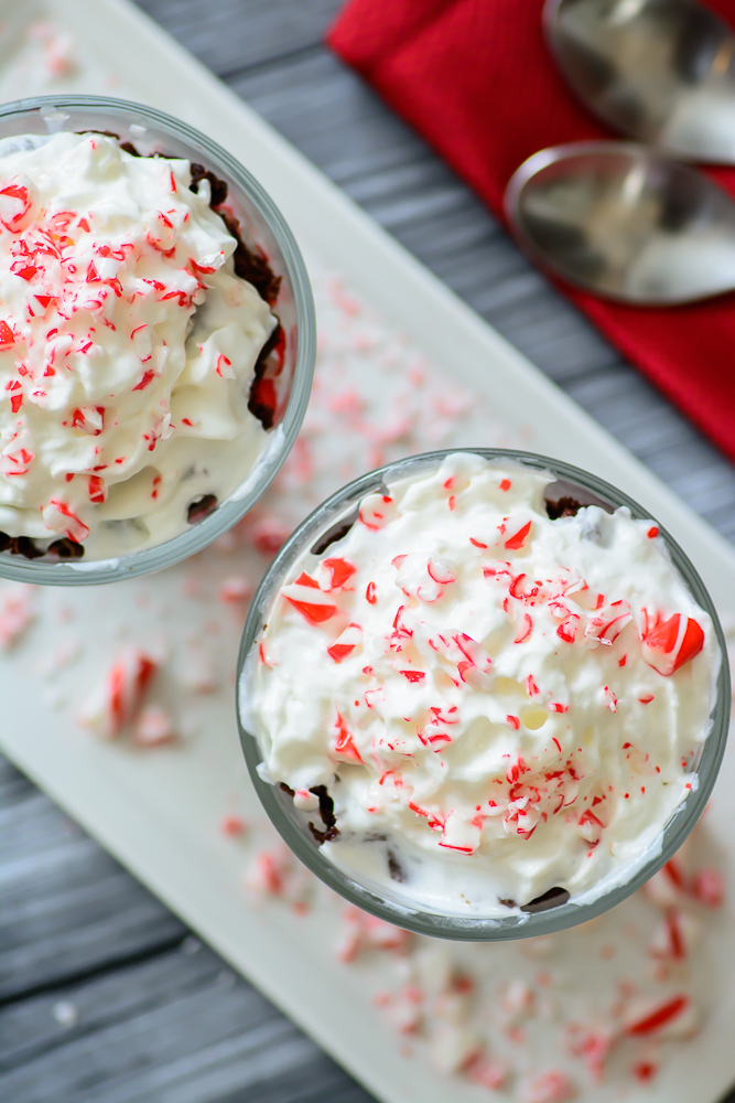 Decadent peppermint brownies topped with whipped cream and crushed candy canes. This peppermint brownie trifle is to die for! YUM!!