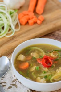 Healthy, low carb, paleo and gluten free alternative to regular chicken noodle soup. Kick it up a notch with the addition of soy sauce, ginger and a little chili pepper. Even if you don't usually like zucchini, you will LOVE this recipe!