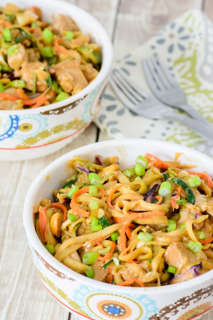 Fresh and healthy One Skillet Thai Peanut Chicken Zoodle Bowl. Made with healthy zucchini noodles, this meal will make your taste buds AND waistline happy. Win-win! You have to try this delicious zoodle recipe!