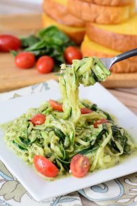 Creamy pesto with fresh zucchini noodles. These are a healthy, low carb, paleo and gluten free alternative to regular noodles. You won't even miss the pasta! Arguably the best zoodle recipe out there.