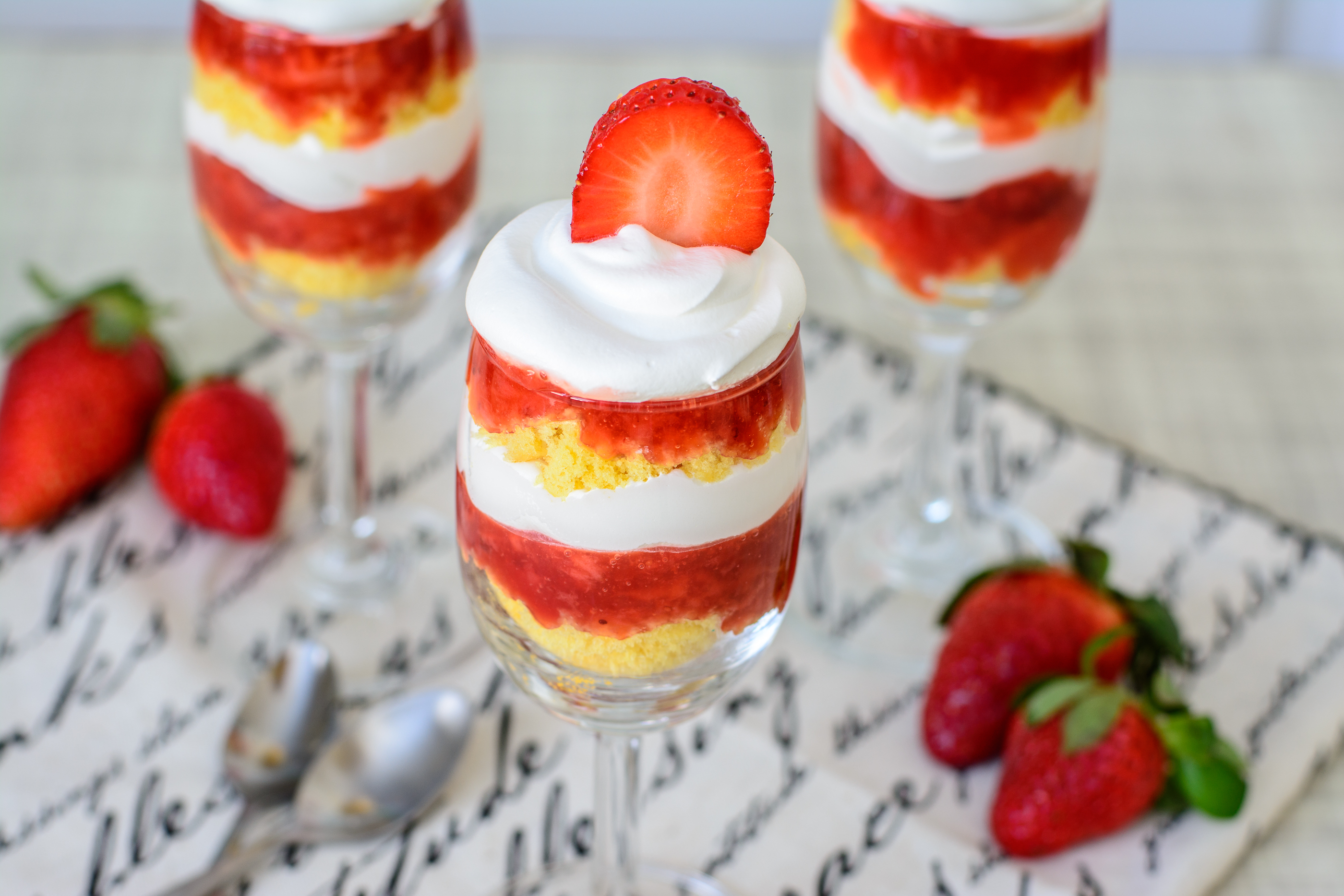 Grain Free Strawberry Shortcake Trifles. This light and delicious trifle layered with strawberry sauce, grain free shortcake and whipped cream is sure to be a hit with the whole family!